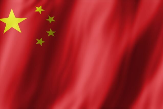 Chinese national flag, showcasing red field and five yellow stars, waving, patriotic concept. People Republic of China flag fluttering in wind, used for propaganda reasons, 3D rendering